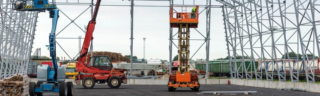 Lift with platform work in warehouse hangar construction field.