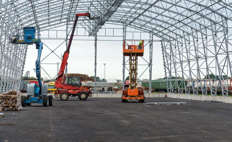 Lift with platform work in warehouse hangar construction field.