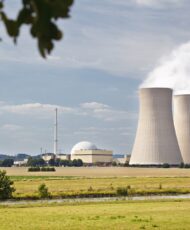 A nuclear power station in green river landscape.